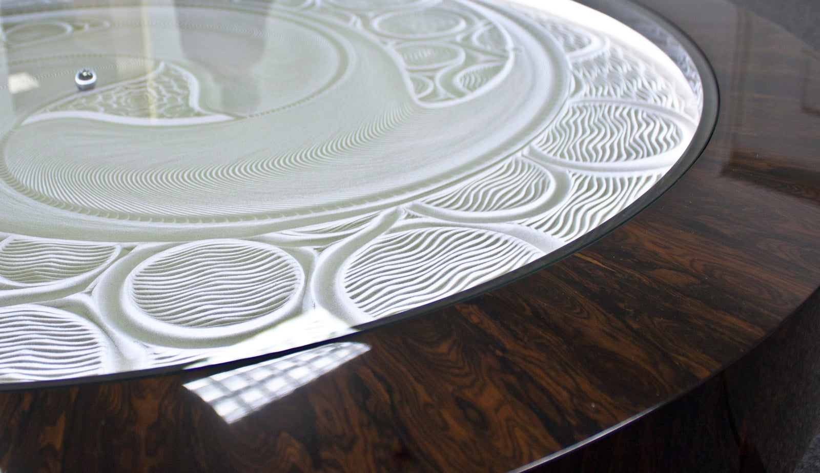 Close up of custom made kinetic art coffee table made of bronze and ziricote