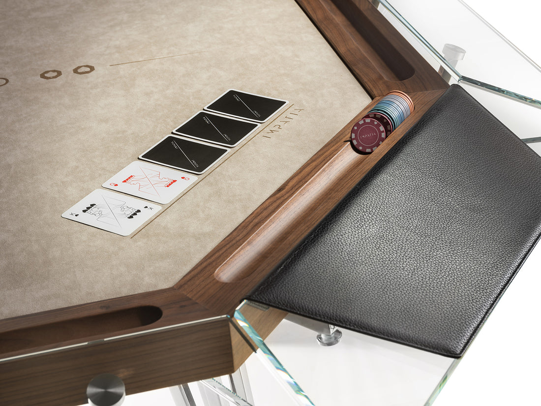 Close up of luxury poker table with wood chip holders, leather armrests, glass trim, and alcantara playing area
