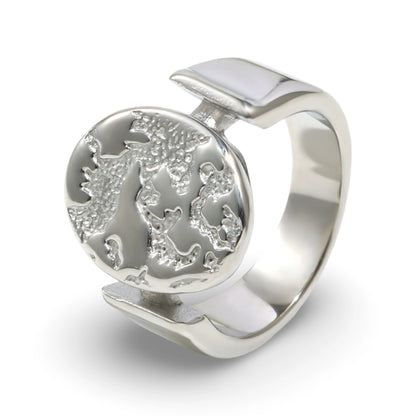 A textured oval ring featuring a raised relief design with an embossed tree motif.