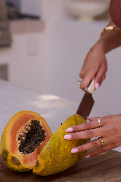 A textured gold ring featuring three small