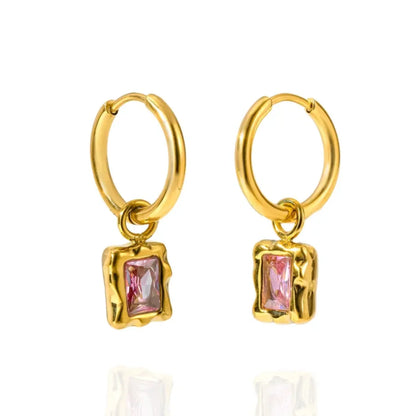 A pair of gold hoop earrings with a small